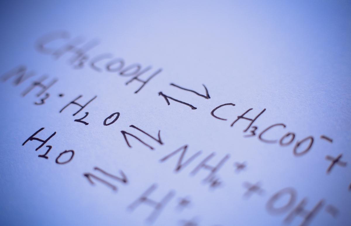 Chemical equation written on a whiteboard